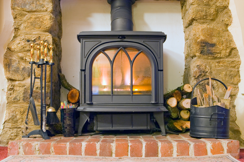 multi fuel fire stove with a stone fireplace surround